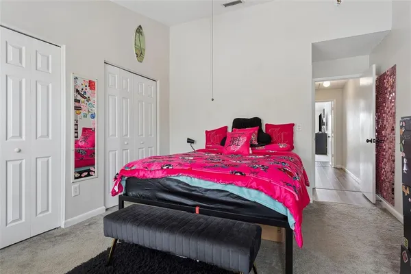 a bedroom with a bed and a closet