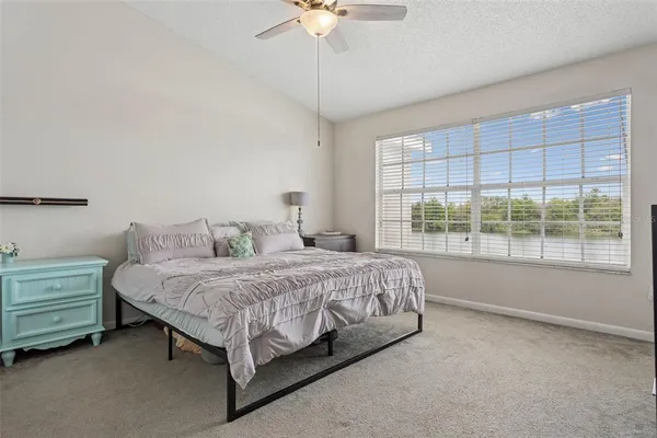 a bed sitting in a bedroom next to a window