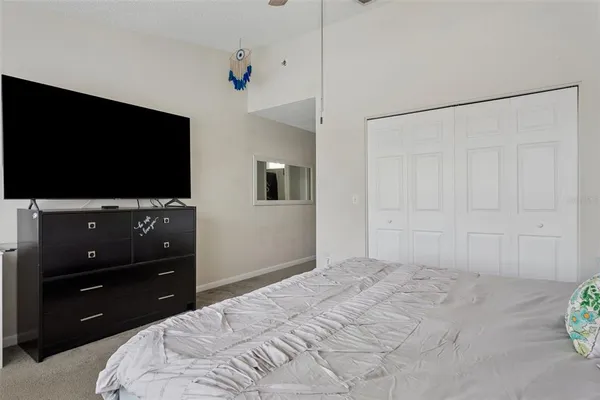 a bedroom with a bed and a flat screen tv