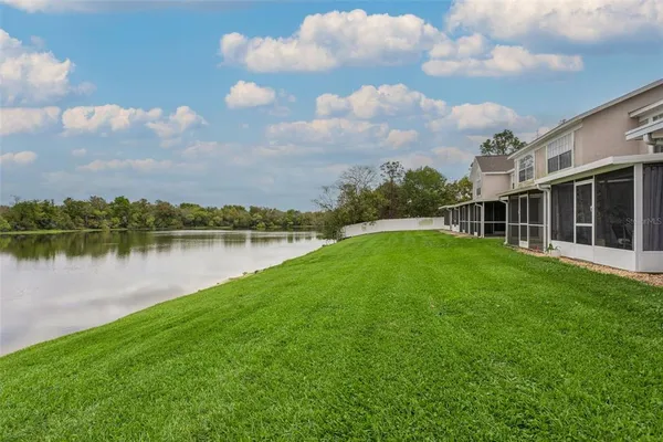 a view of a backyard with a swimming pool and sitting area
