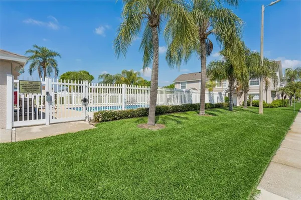 a front view of a house with a yard and potted plants