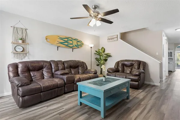 a living room with furniture and a potted plant