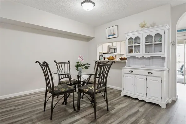 a view of a dining room with furniture and wooden floor