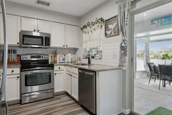 a kitchen with a sink stove and microwave