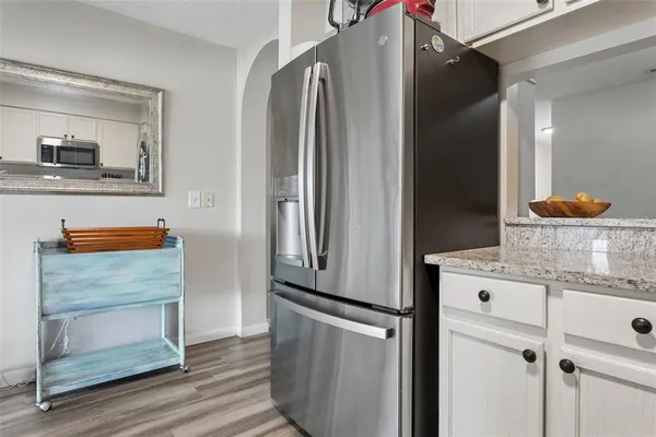 a kitchen with a refrigerator and cabinets