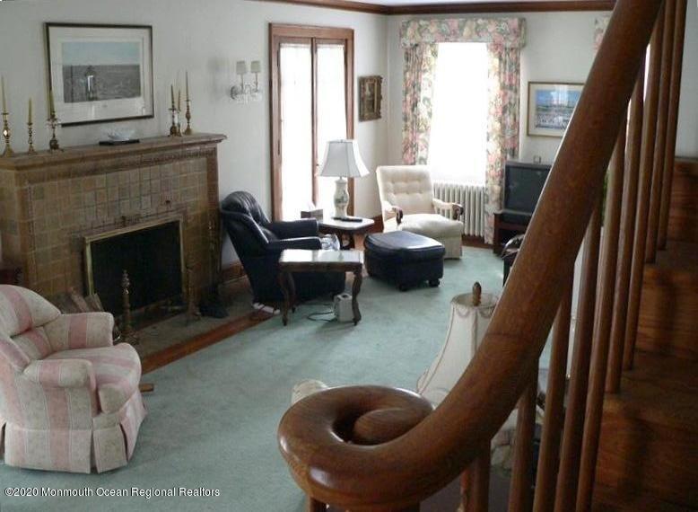 212 Monroe Avenue Spring Lake, NJ 07762 - Photo 5 of 13 a living room with furniture and a fireplace