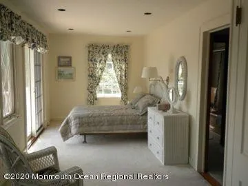 a en suite bathroom with a granite countertop sink and a mirror