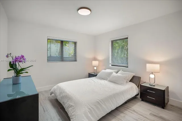 a bedroom with a bed and a potted plant