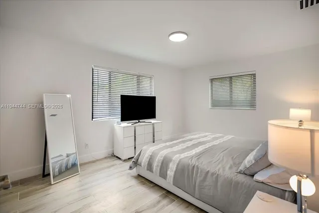 a bedroom with a bed and a flat screen tv