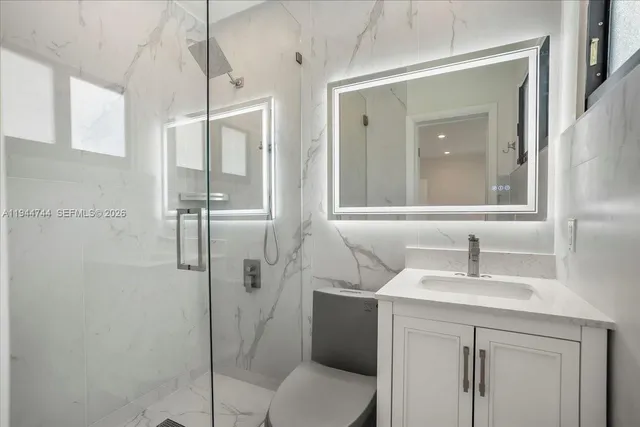 a bathroom with a sink toilet and shower