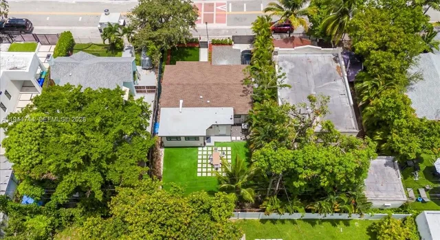 an aerial view of a house with a yard and garden