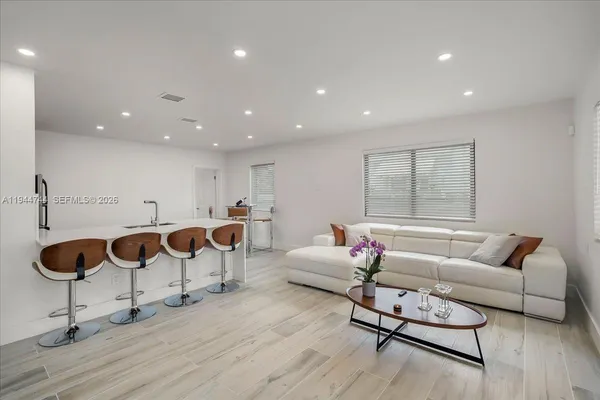 a living room with furniture and wooden floor