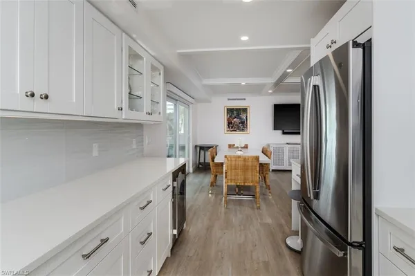 a kitchen with stainless steel appliances granite countertop a refrigerator and a sink