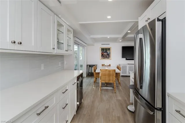 a kitchen with stainless steel appliances granite countertop a refrigerator and a sink