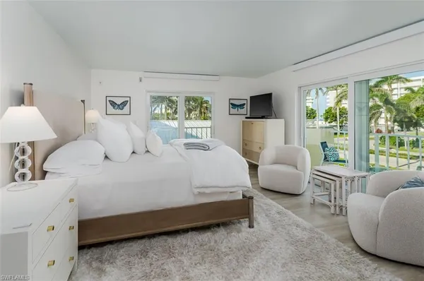 a bedroom with bed and a large window