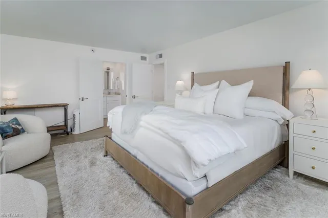 a large bed sitting in a bedroom and lamp