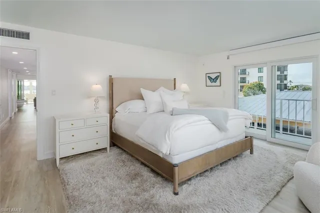 a view of a bedroom with furniture and large window