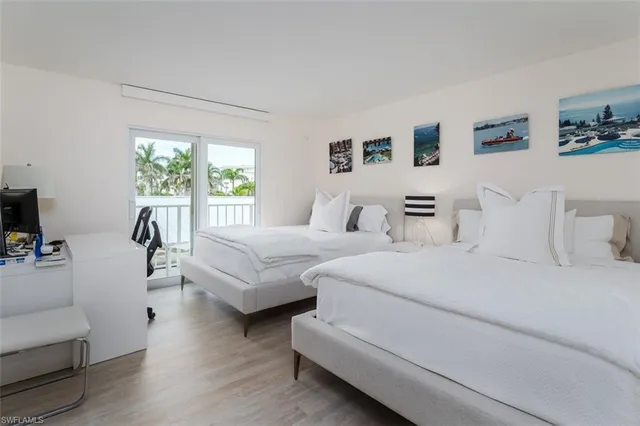 a bedroom with furniture and a large window