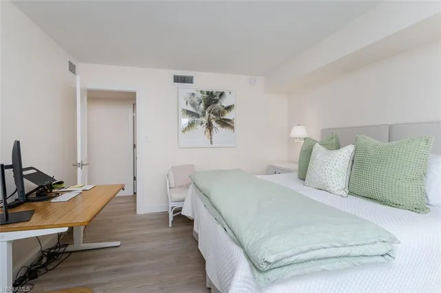 a bed room with a bed and a chair