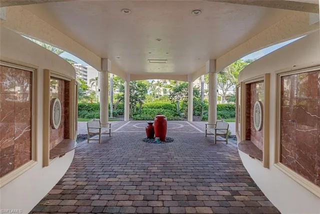 a front view of multi story residential apartment building with yard and green space