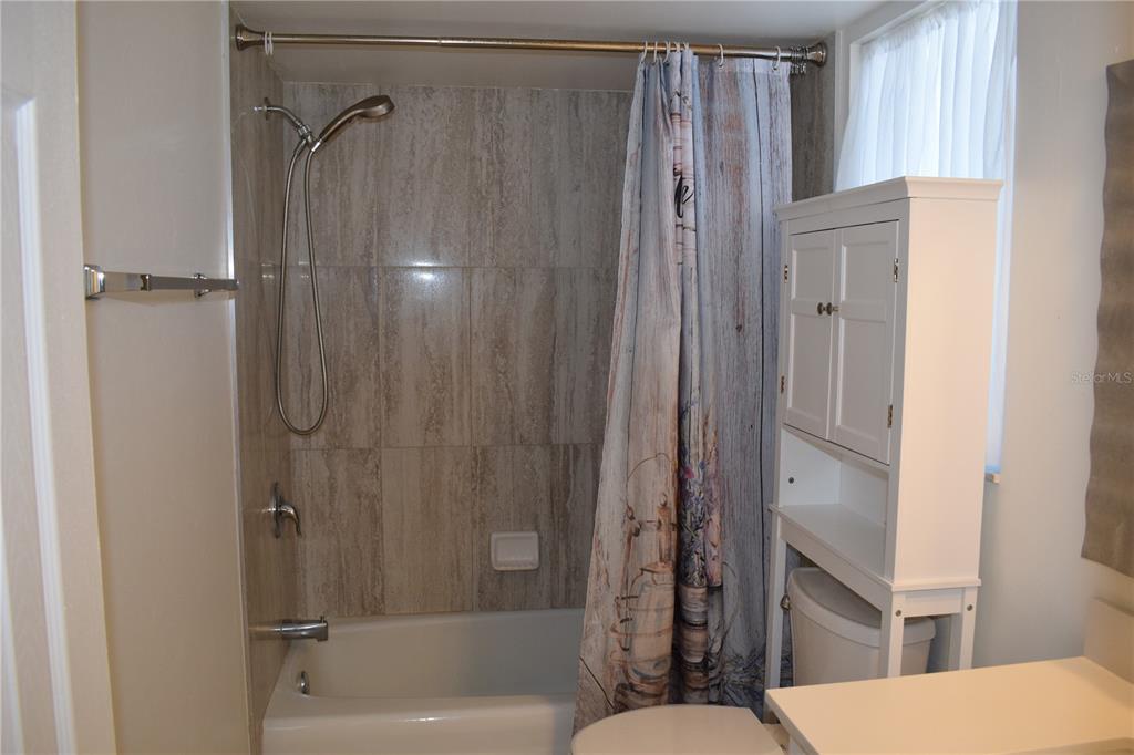 245 Center Road, Unit 104 Venice, FL 34285 - Photo 35 of 37 a bathroom with a shower and a toilet