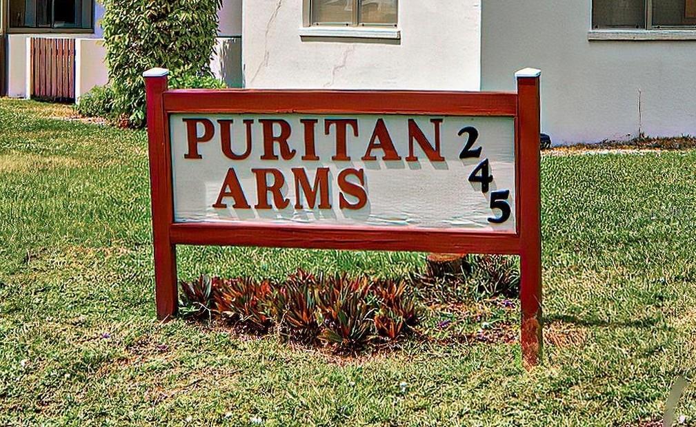 245 Center Road, Unit 104 Venice, FL 34285 - Photo 37 of 37 a street sign that is sitting on a brick wall