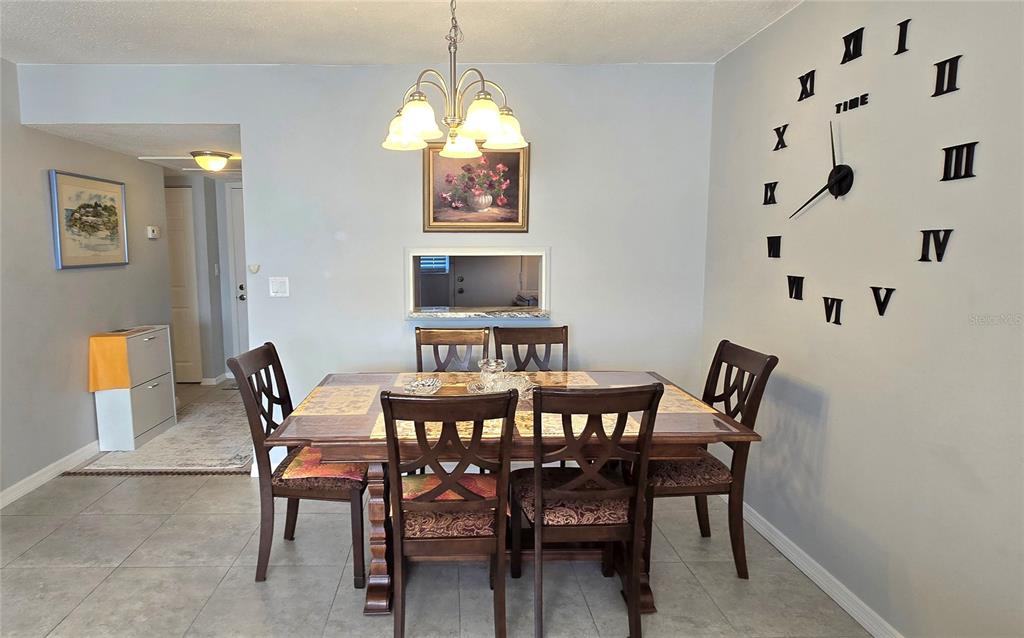 245 Center Road, Unit 104 Venice, FL 34285 - Photo 10 of 37 a view of a dining room with furniture and chandelier