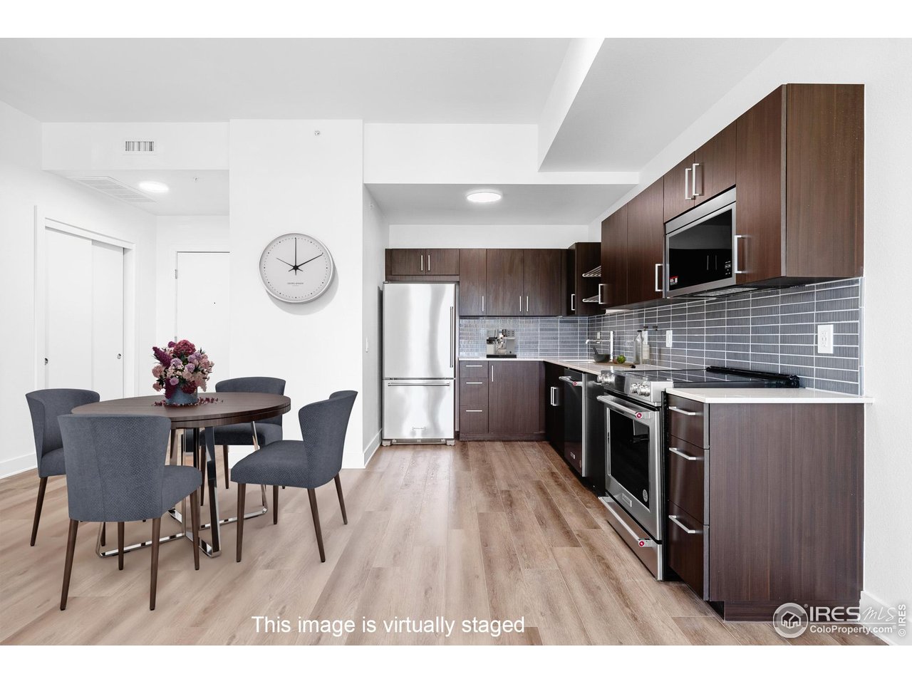 a kitchen with stainless steel appliances kitchen island granite countertop a stove a sink a microwave and wooden cabinets