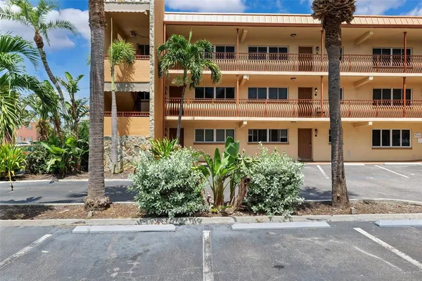 a living room with furniture a flat screen tv and a potted plant