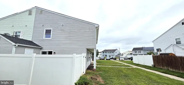 a view of a house with a yard and sitting area