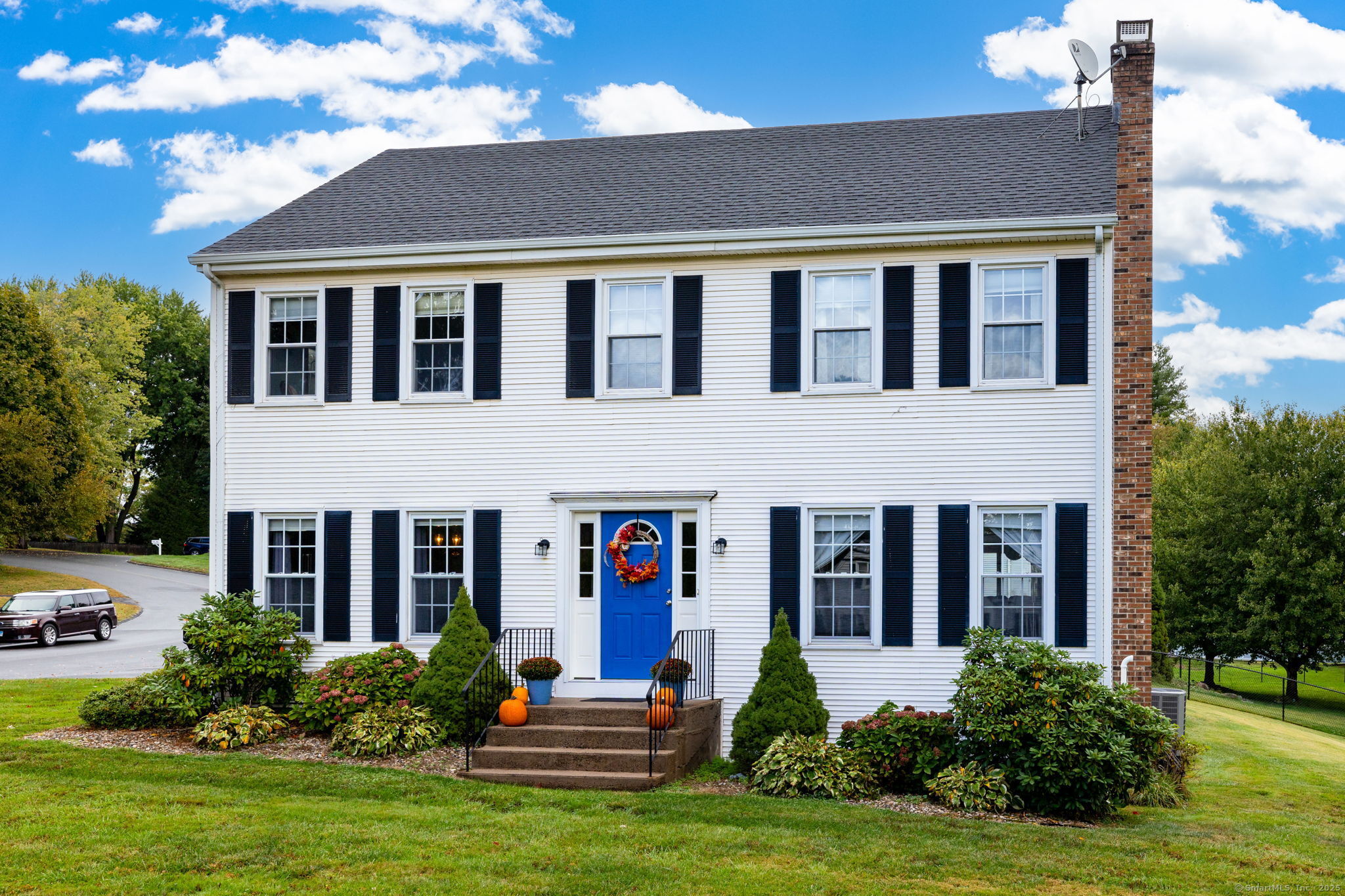 a front view of a house with garden and porch