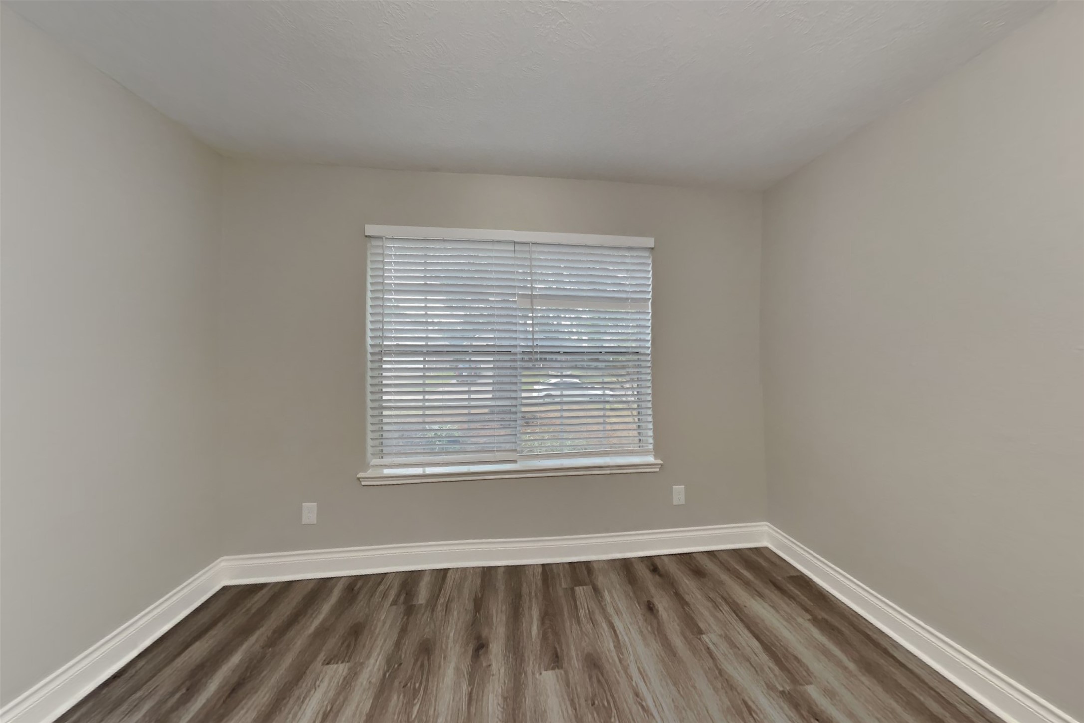 20314 Savannah Bay Road Cypress, TX 77433 - Photo 5 of 21 a view of an empty room with wooden floor and a window
