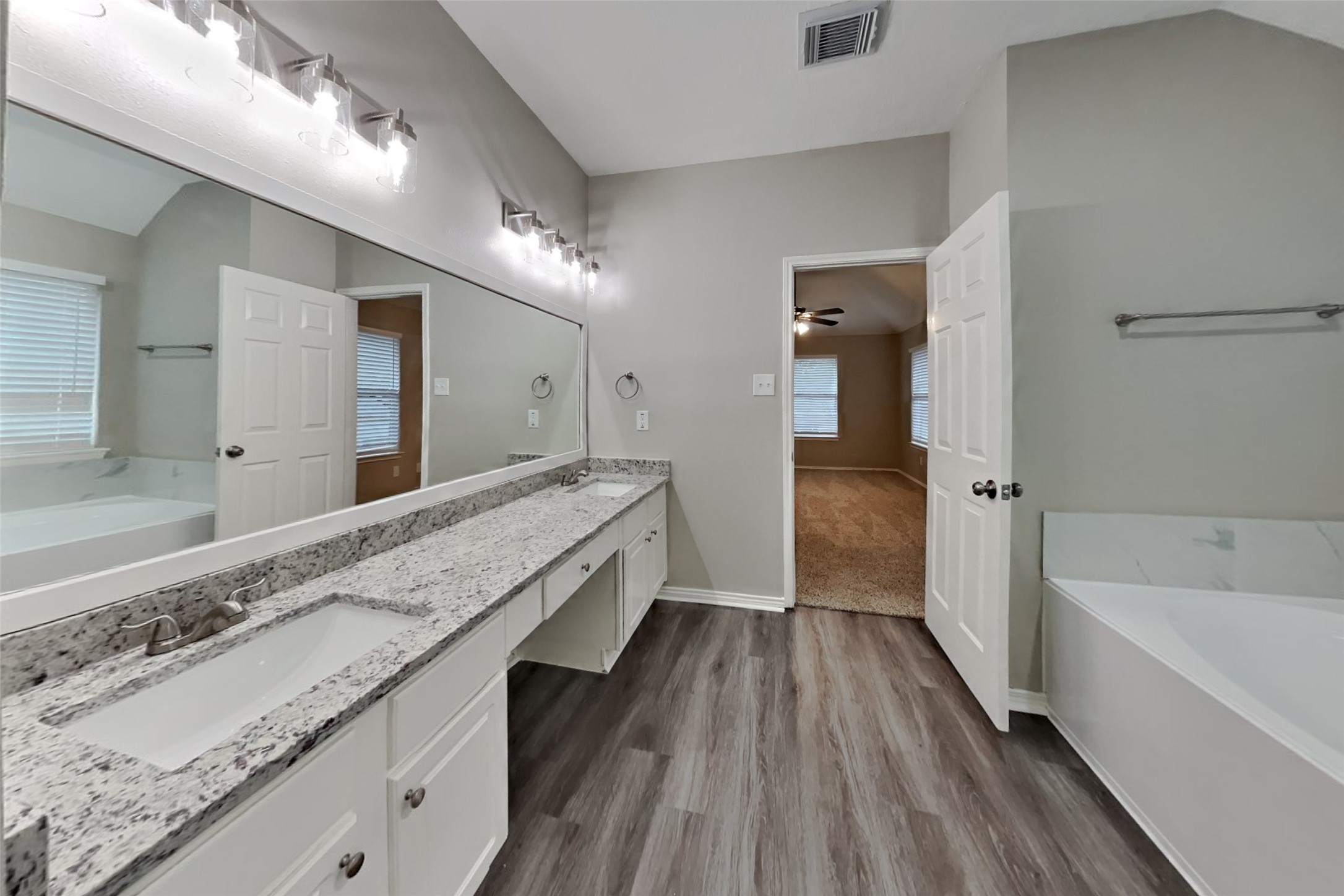 20314 Savannah Bay Road Cypress, TX 77433 - Photo 10 of 21 a bathroom with a granite countertop sink mirror and bathtub