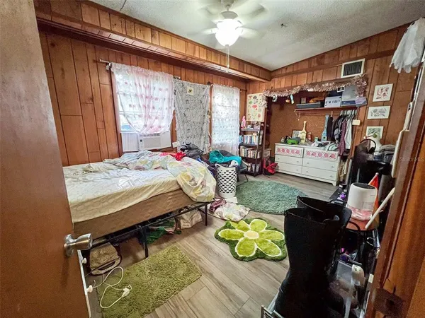 a bedroom with a bed mirror and a window