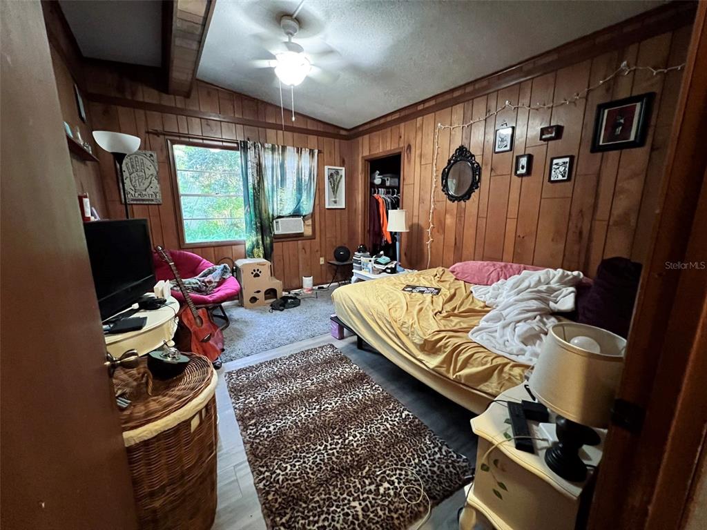 630 Northwest 36th Street Gainesville, FL 32607 - Photo 15 of 22 a bed room with a bed window and a chair