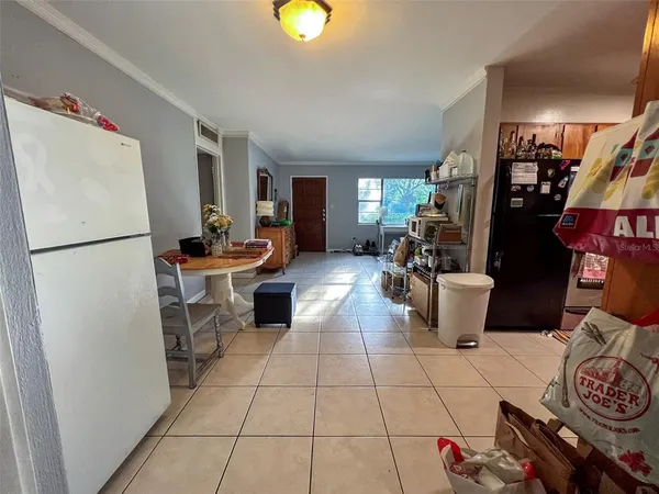 a kitchen with a refrigerator and a stove