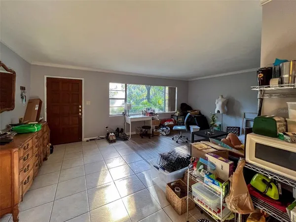 a room with furniture a flat screen tv and a window