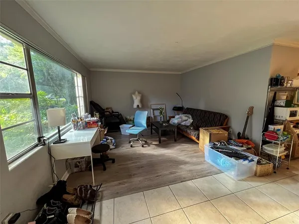 a room with furniture a large window and a book shelf