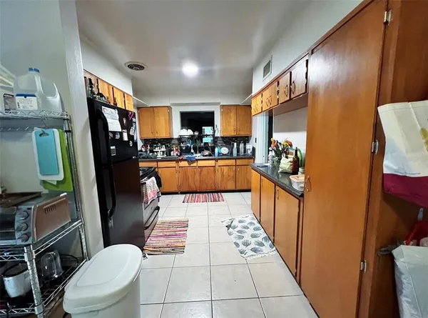 a bathroom with a sink a toilet a mirror and shower