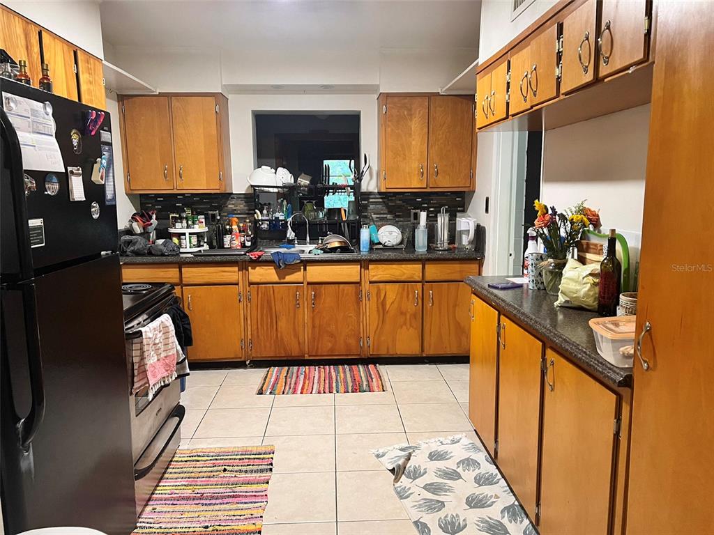 630 Northwest 36th Street Gainesville, FL 32607 - Photo 6 of 22 a kitchen with stainless steel appliances granite countertop a sink and a refrigerator