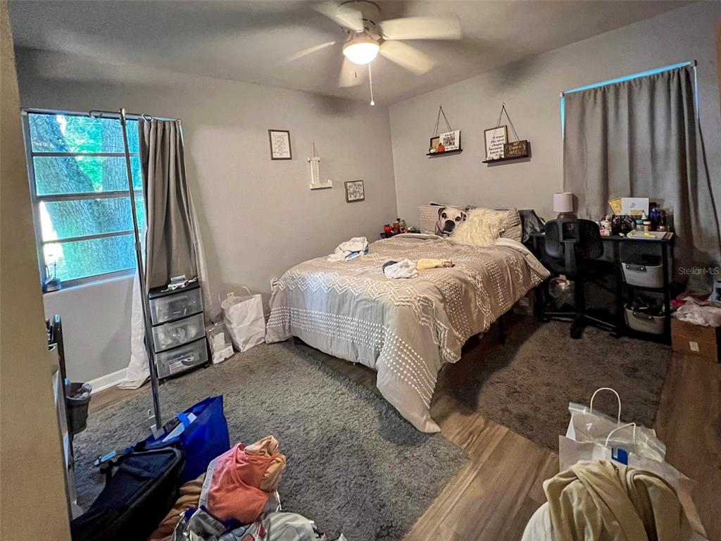 630 Northwest 36th Street Gainesville, FL 32607 - Photo 9 of 22 a bedroom with a bed and a tv