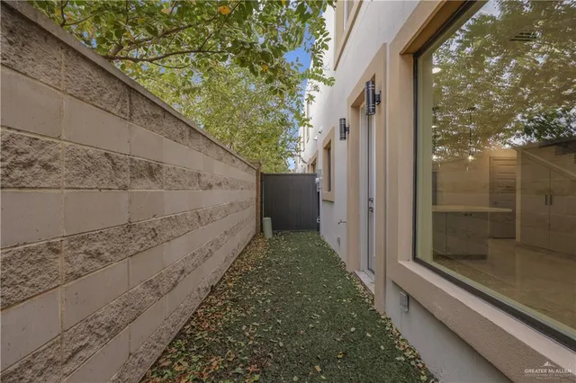 a view of a pathway of a house with a yard
