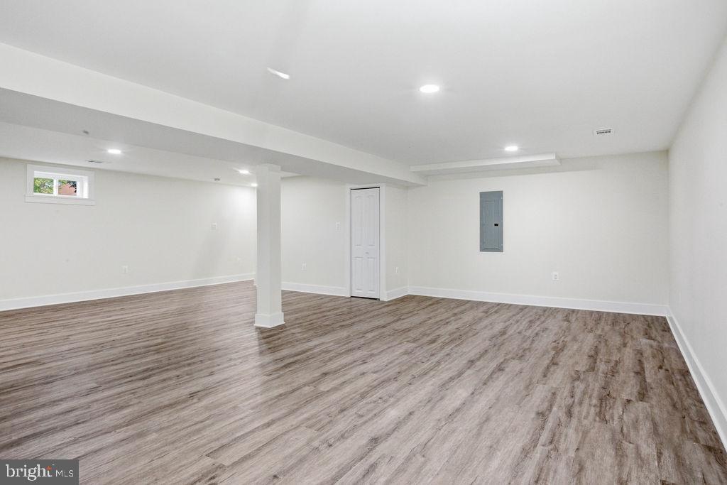 6620 Napoli Road Temple Hills, MD 20748 - Photo 21 of 38 a view of an empty room with wooden floor and a window