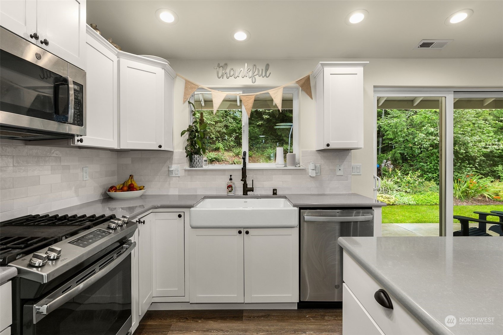 9924 Angeline Road East Bonney Lake, WA 98391 - Photo 11 of 31 a kitchen with a sink stove top oven and cabinets