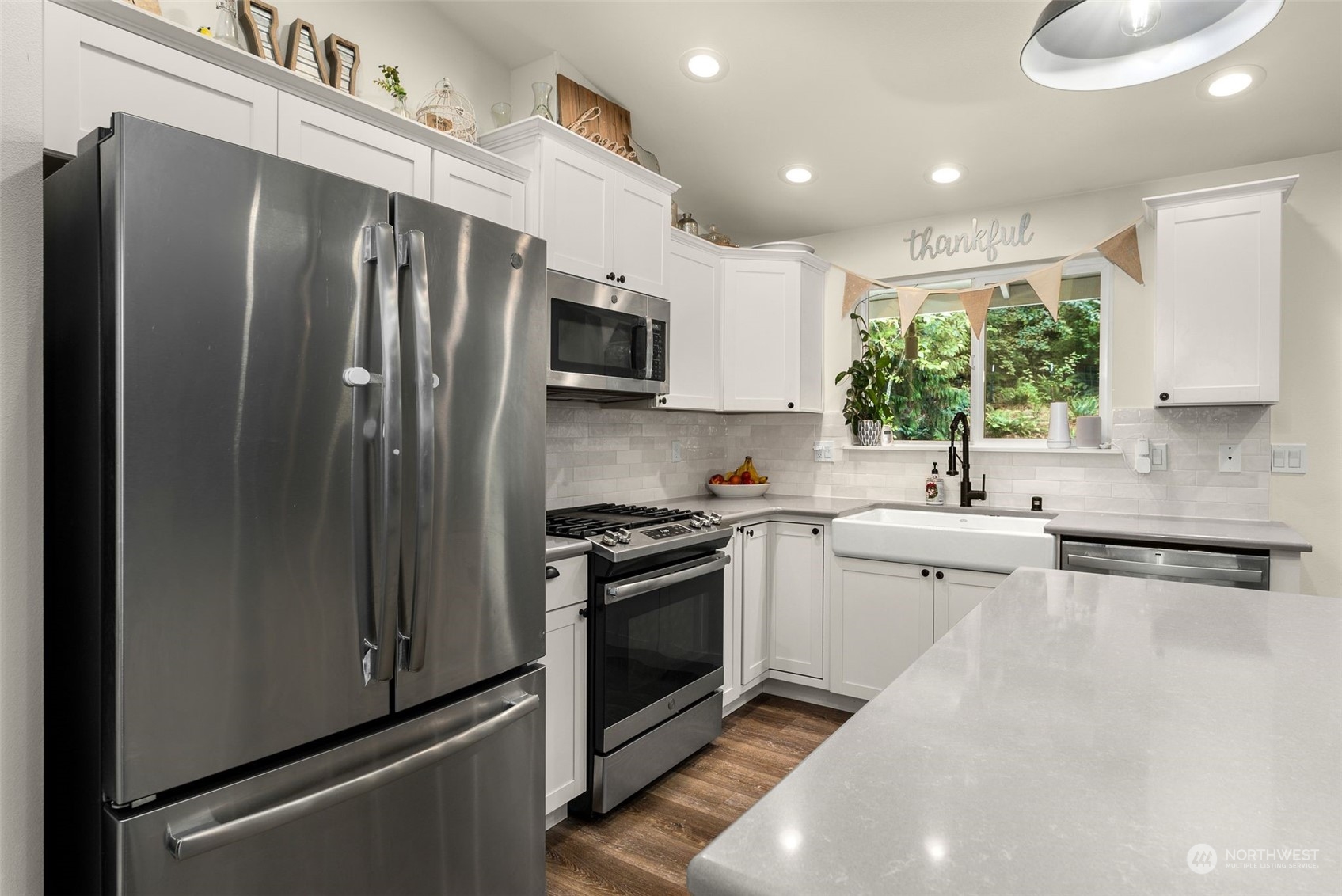 9924 Angeline Road East Bonney Lake, WA 98391 - Photo 12 of 31 a kitchen with stainless steel appliances granite countertop a refrigerator sink and stove