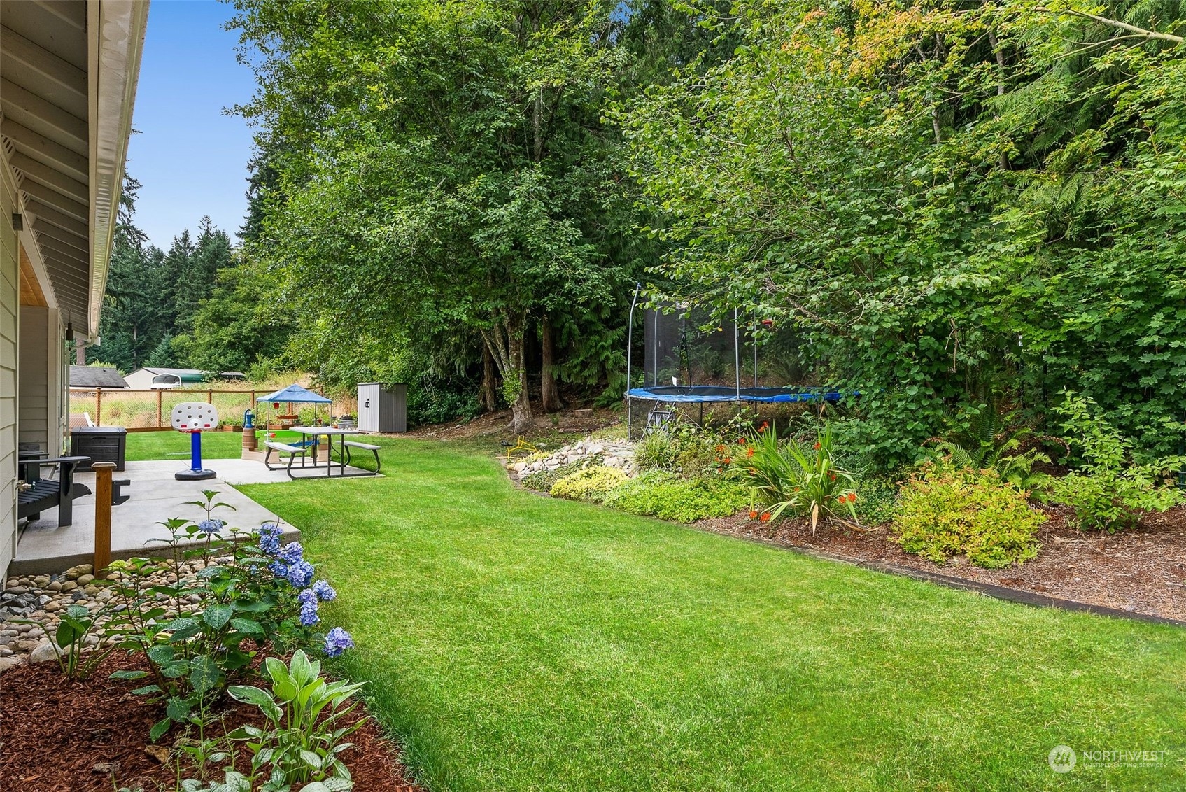 9924 Angeline Road East Bonney Lake, WA 98391 - Photo 26 of 31 a view of backyard with a garden and trees