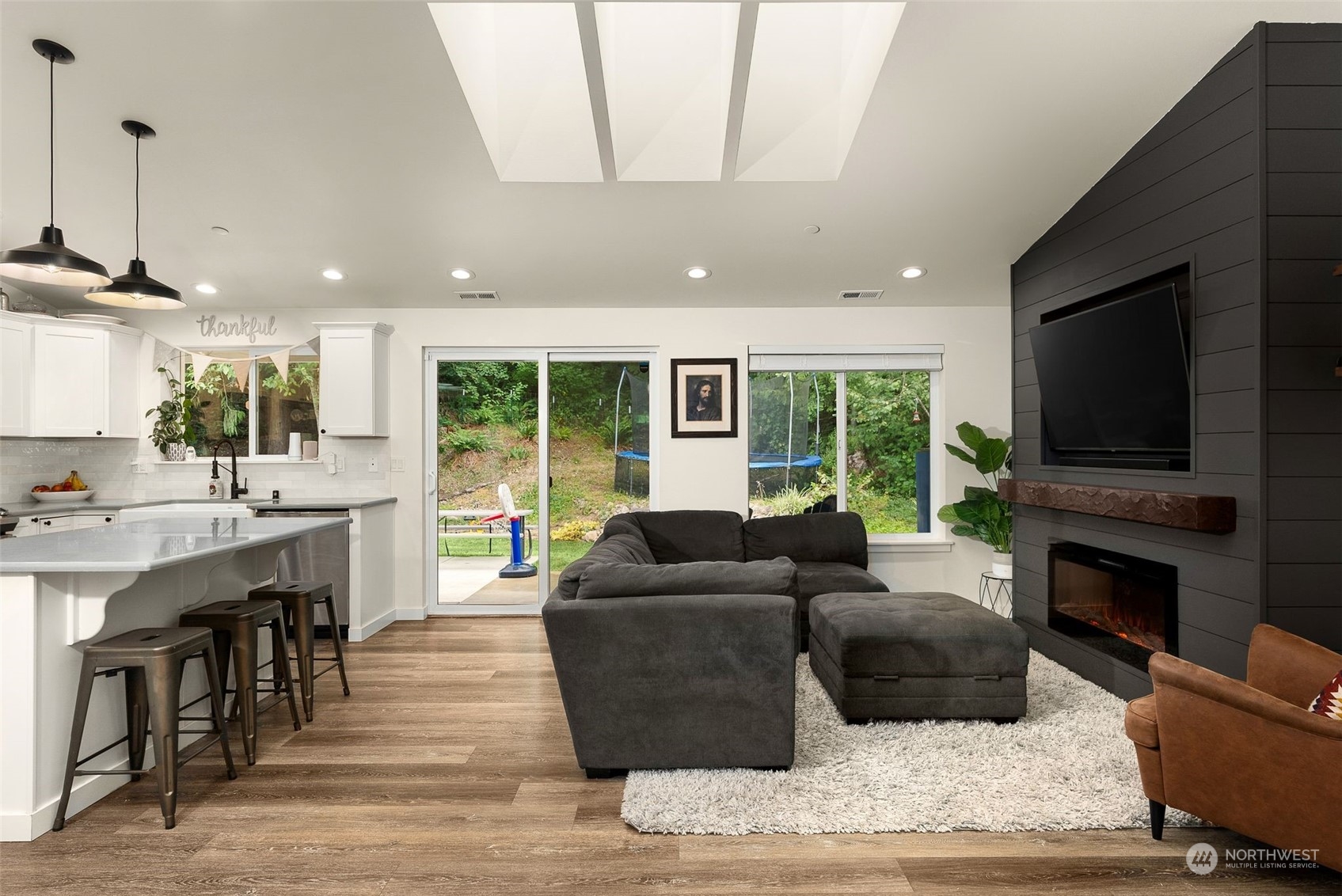 9924 Angeline Road East Bonney Lake, WA 98391 - Photo 3 of 31 a living room with furniture a flat screen tv and a fireplace
