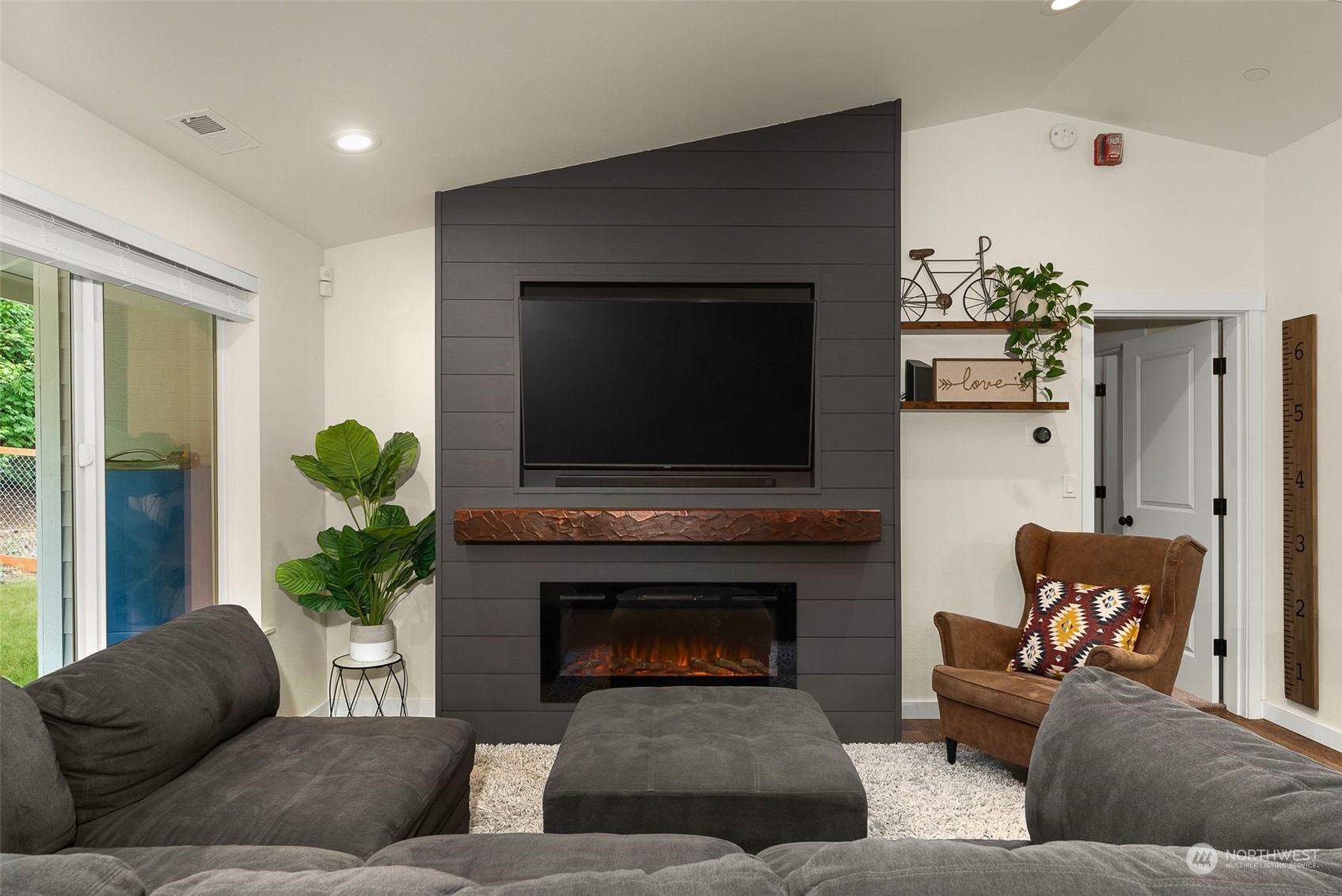 9924 Angeline Road East Bonney Lake, WA 98391 - Photo 5 of 31 a living room with furniture a flat screen tv and a fireplace