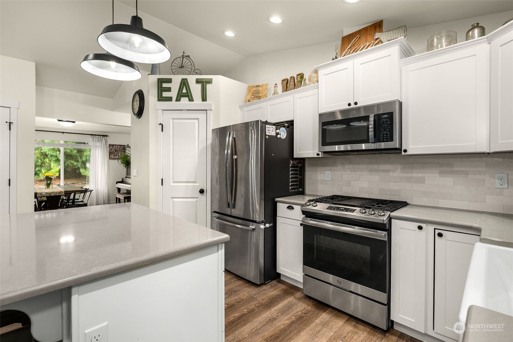 9924 Angeline Road East Bonney Lake, WA 98391 - Photo 10 of 31 a kitchen with stainless steel appliances a stove a microwave and a refrigerator