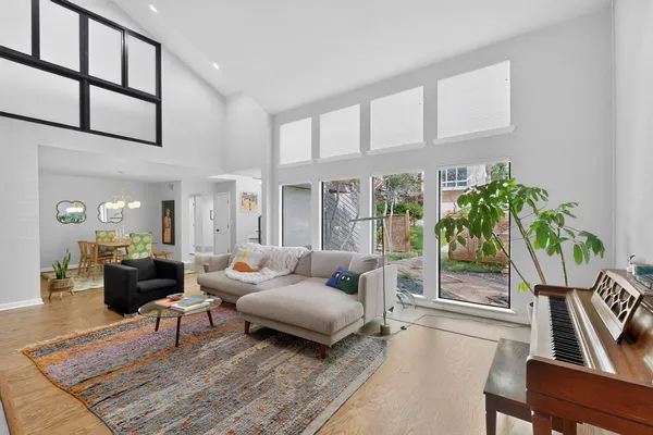 a living room with furniture a table and a potted plant